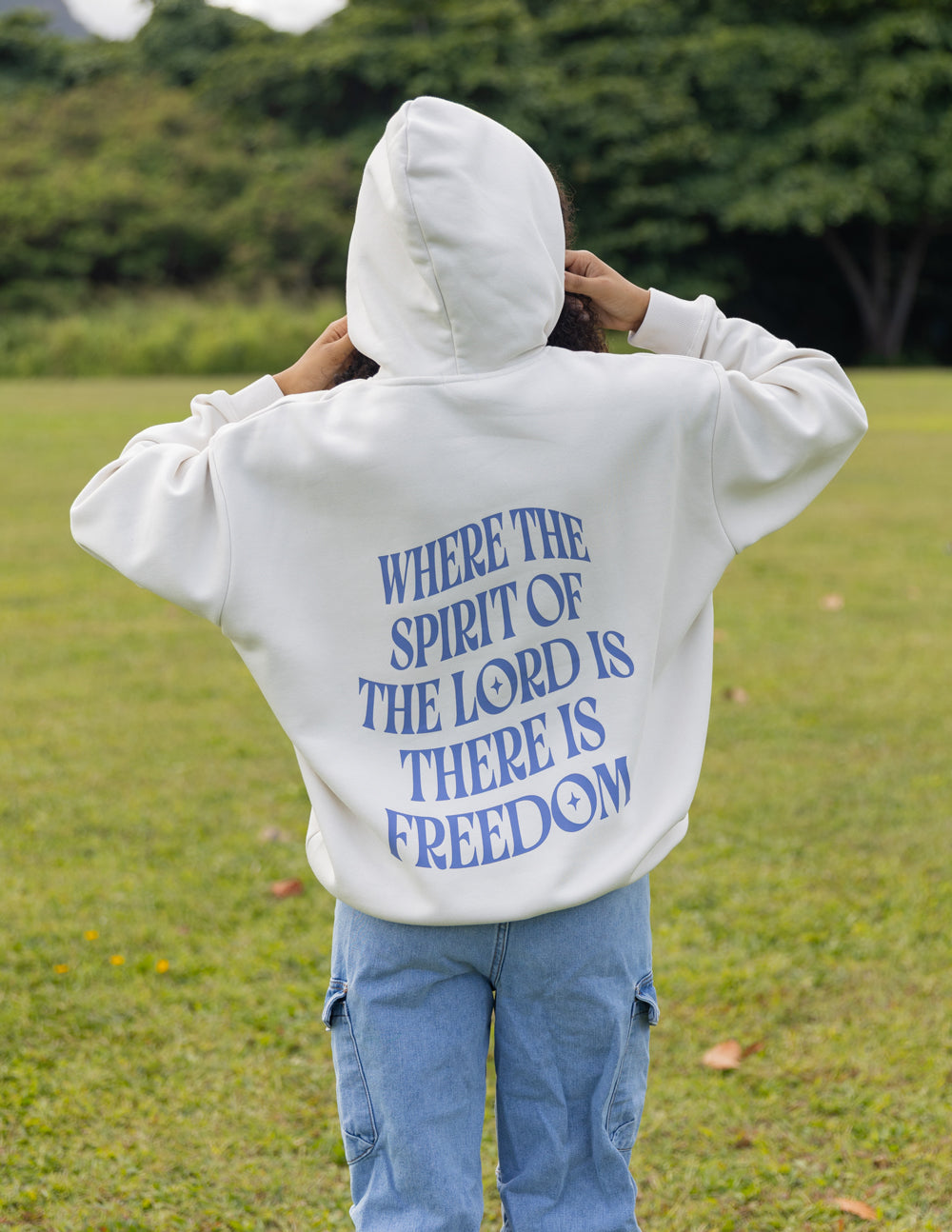 White unisex hoodie with blue back quote text centered on the upper back