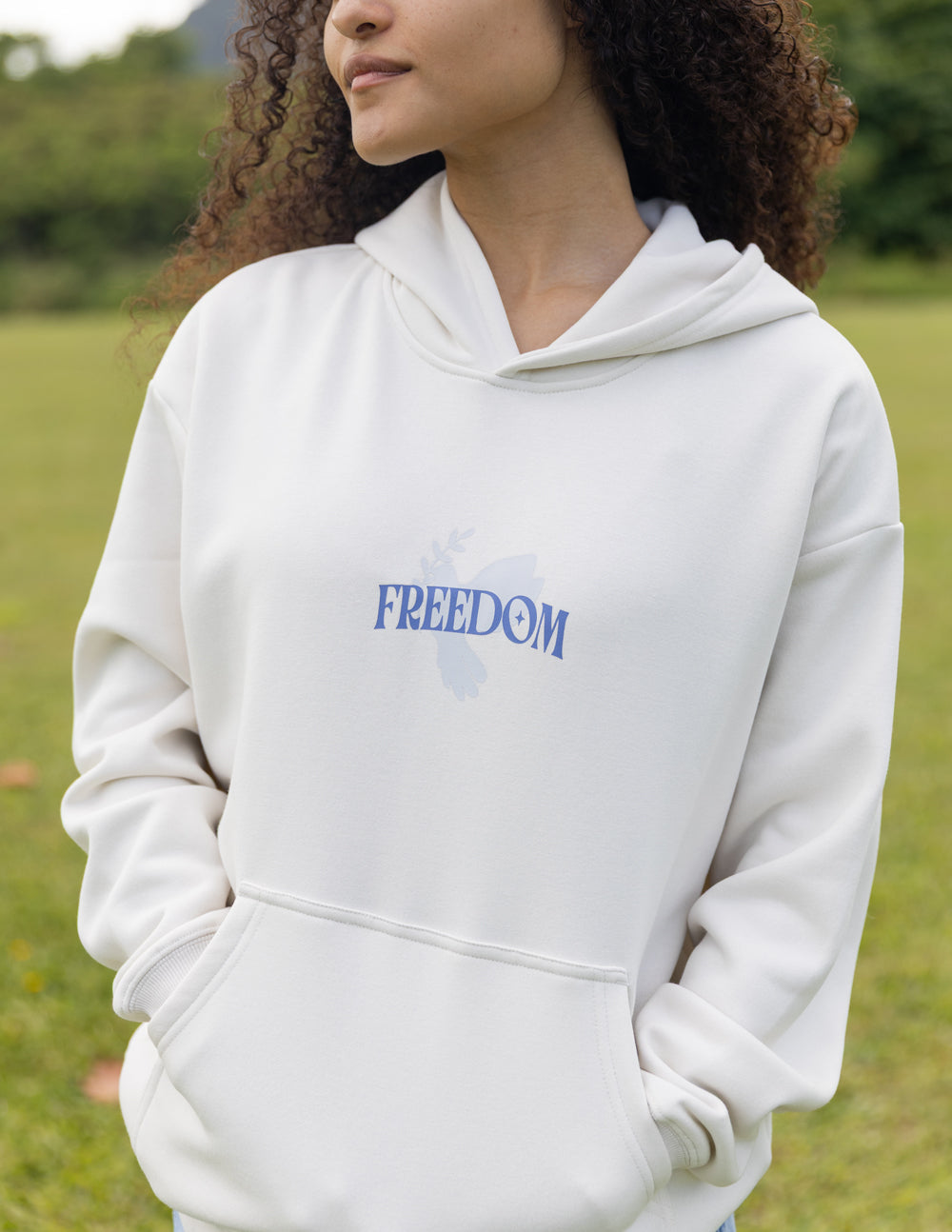 White unisex hoodie with blue "FREEDOM" logo on the chest, front view