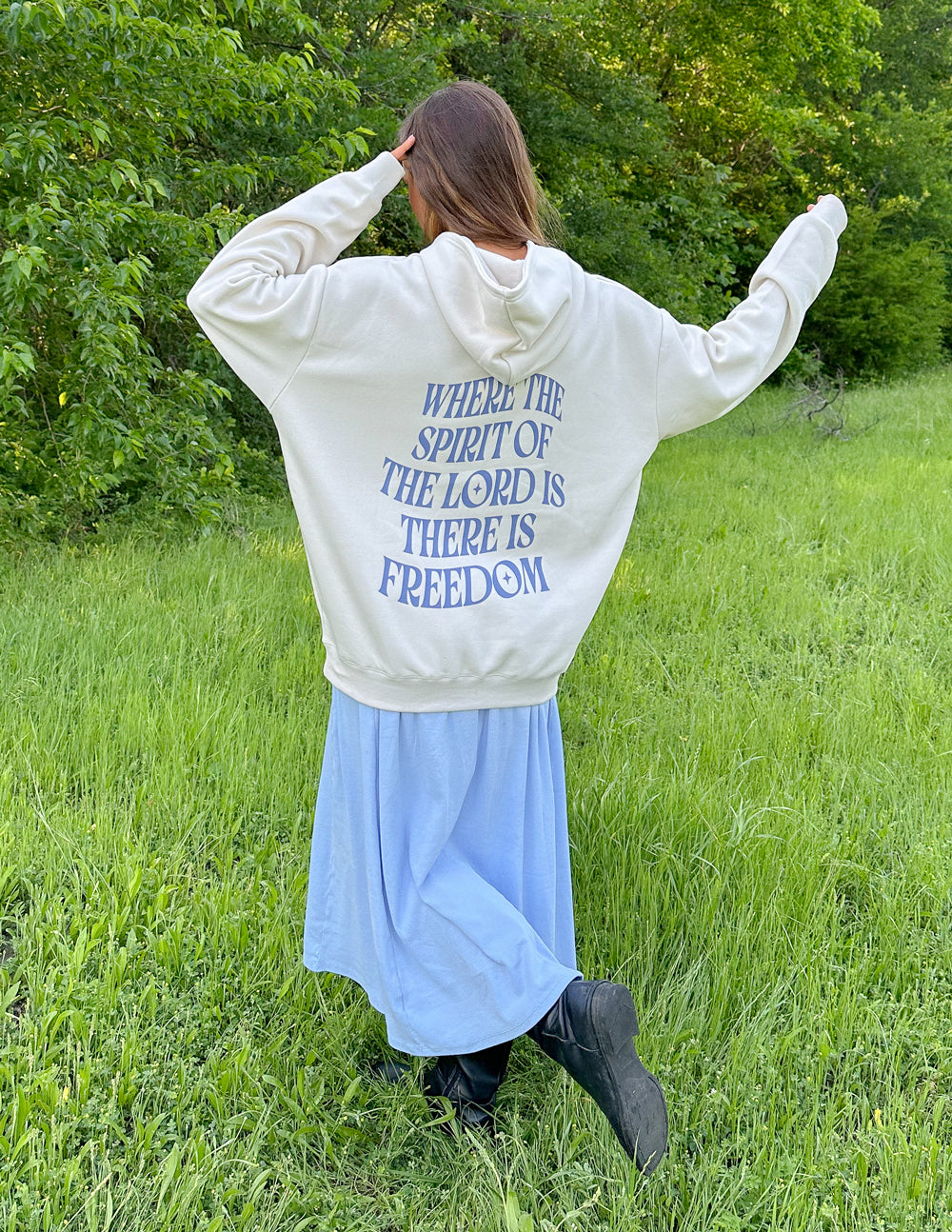 White unisex hoodie with blue back text: "WHERE THE SPIRIT OF THE LORD IS THERE IS FREEDOM"