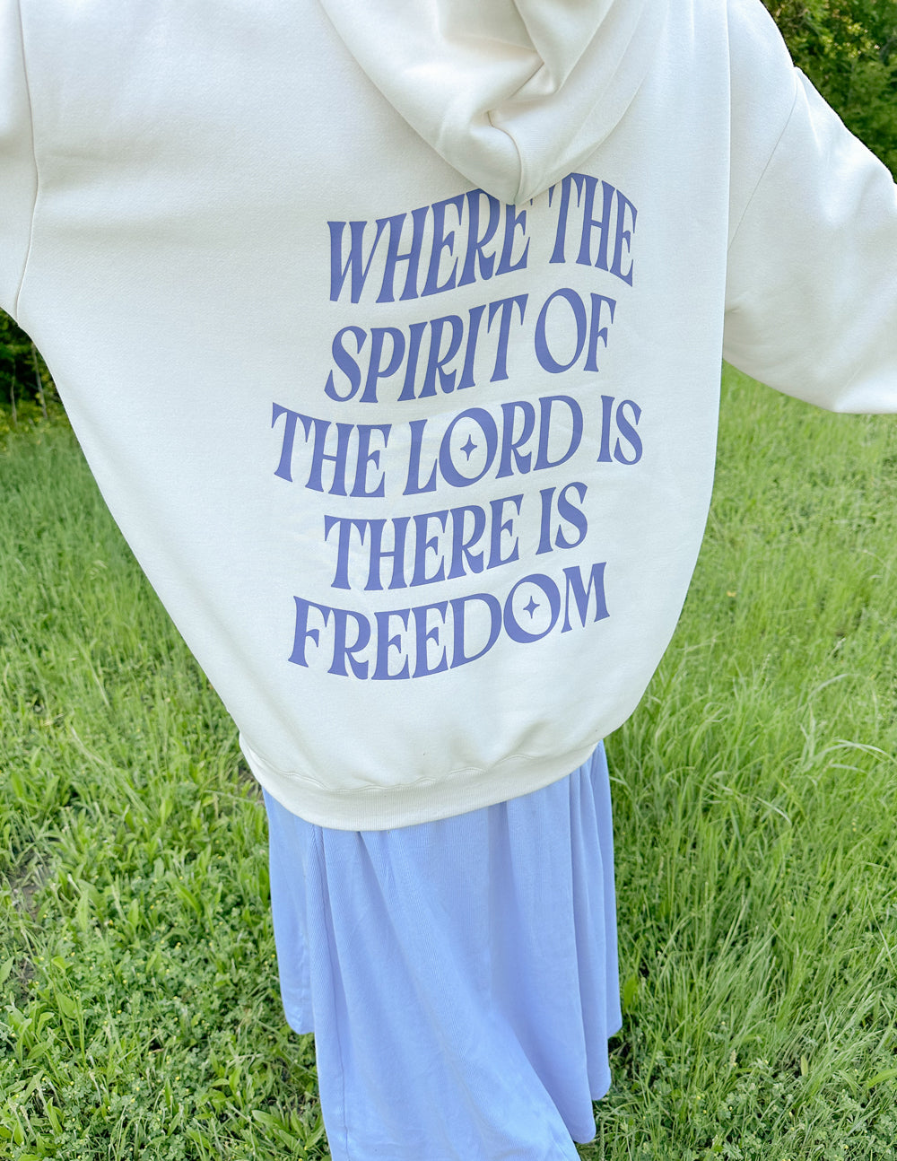 White unisex hoodie with blue front back graphic text: "WHERE THE SPIRIT OF THE LORD IS FREEDOM"