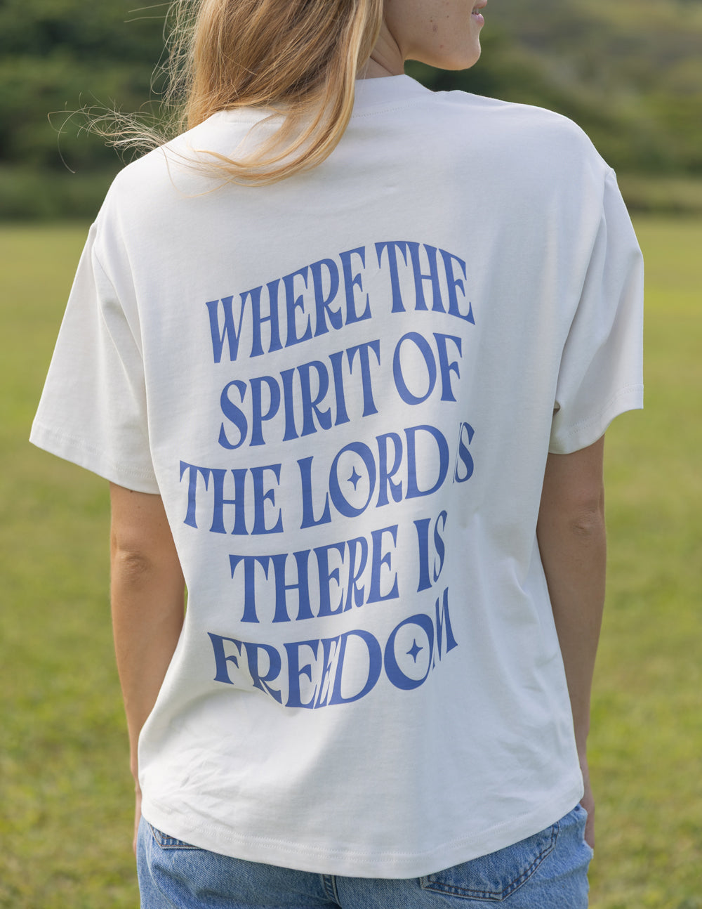 White unisex T-shirt back with blue quote text and "FREEDOM"