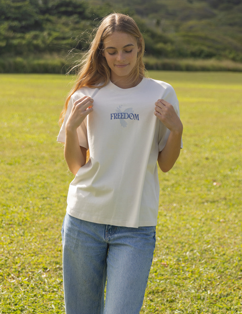 White unisex T-shirt with small blue "FREEDOM" logo on front