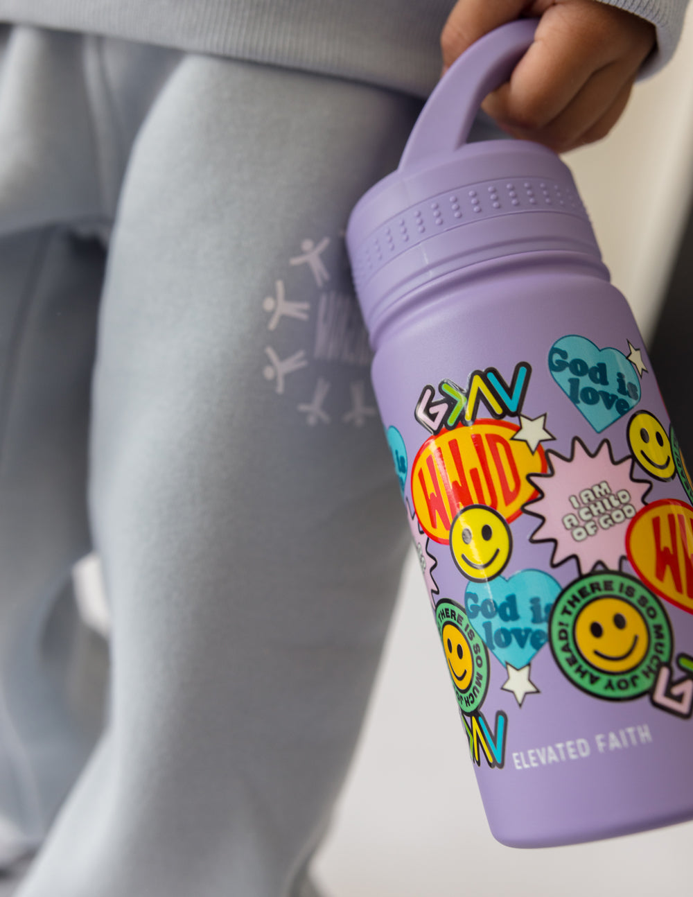 Lavender kids water bottle with colorful sticker collage and smiley icons, flip spout