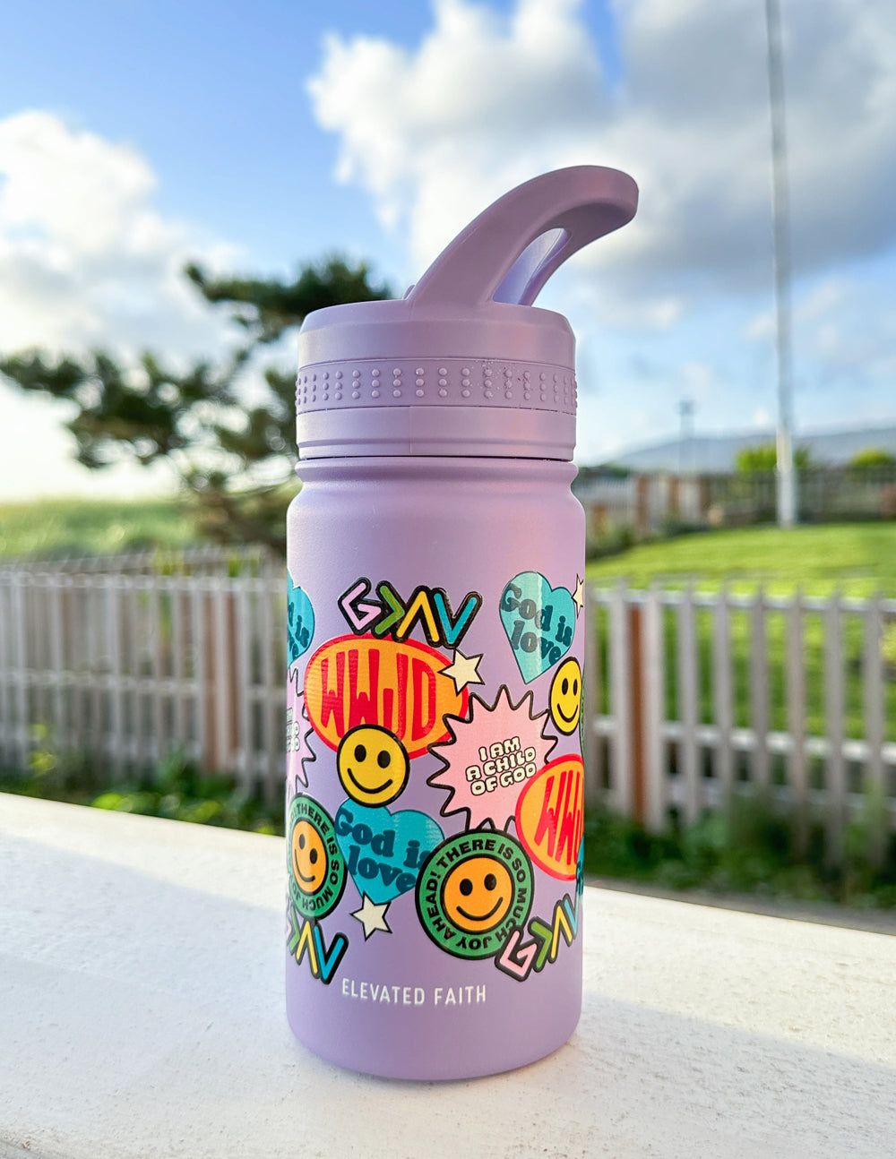 Lavender kids water bottle with colorful sticker collage and flip spout, front view