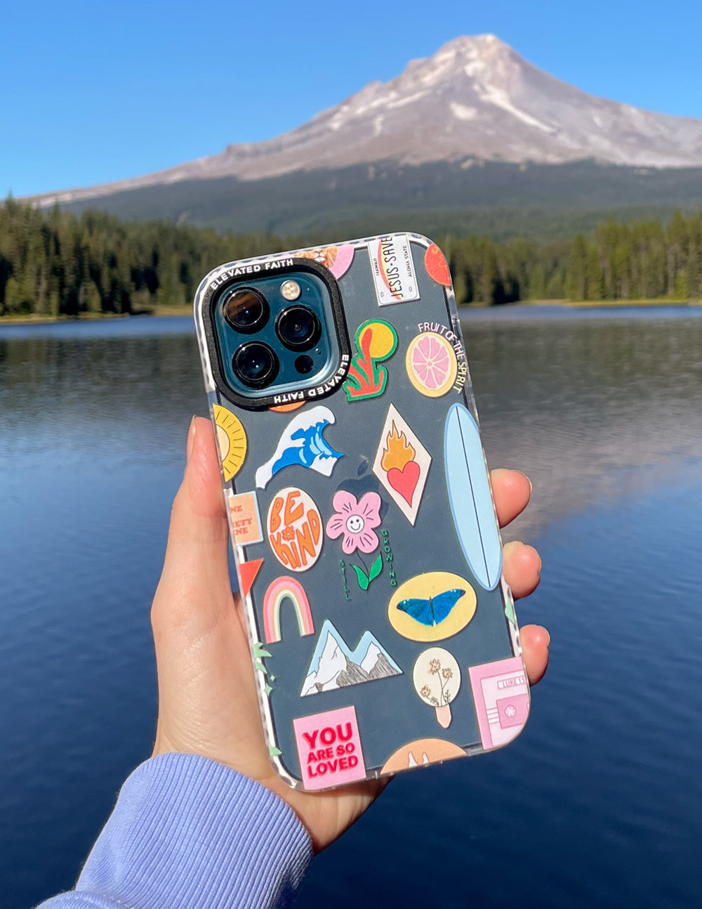 Phone case with sticker collage graphic, light base, dual camera and flash cutouts