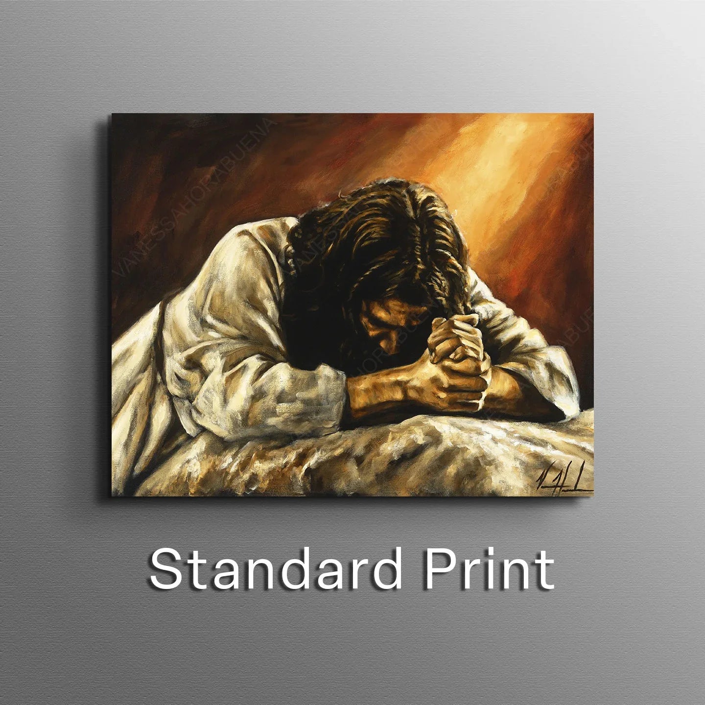 Framed giclée print of a man praying with hands clasped on a bed