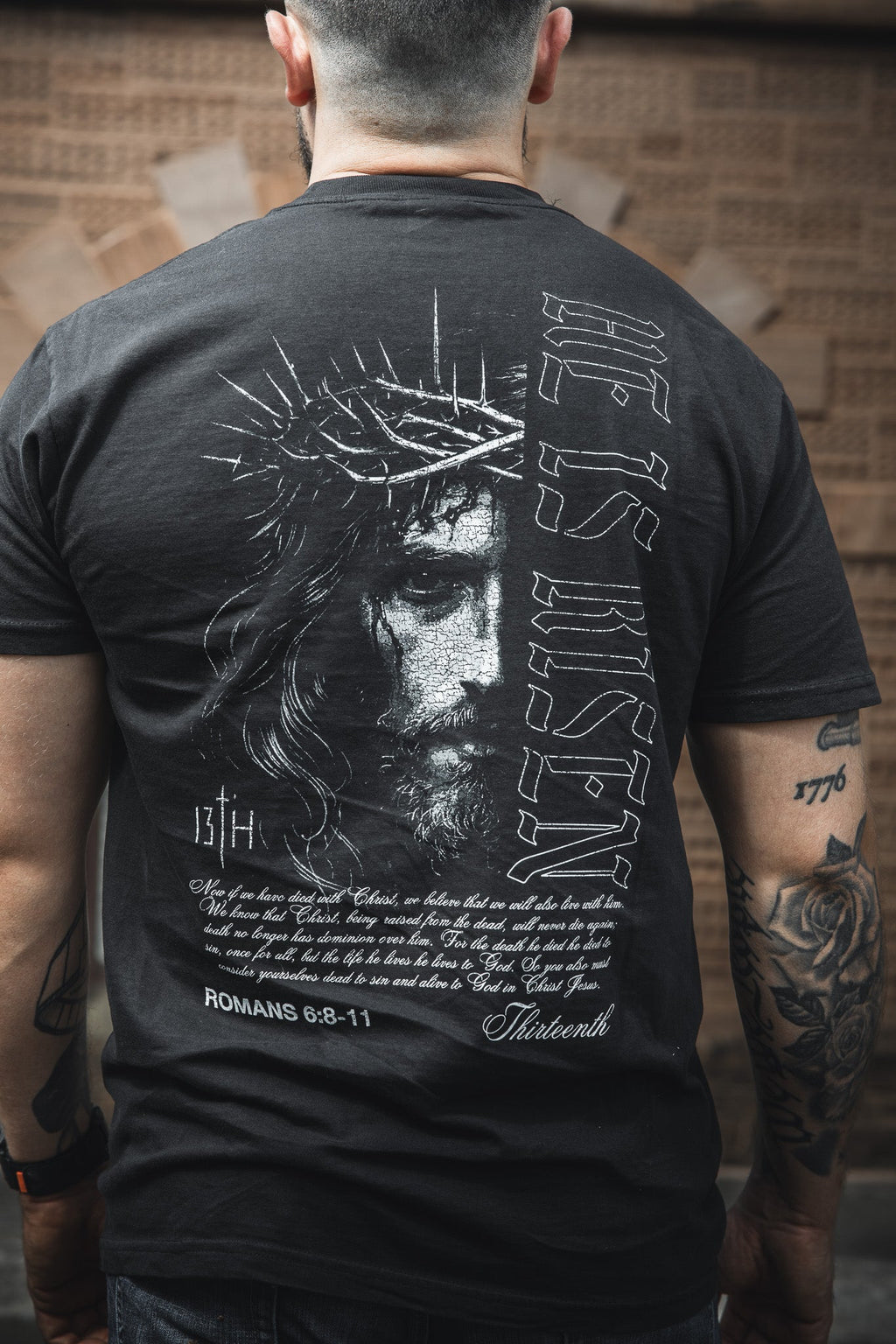 Black graphic t-shirt with large back portrait and Bible text print