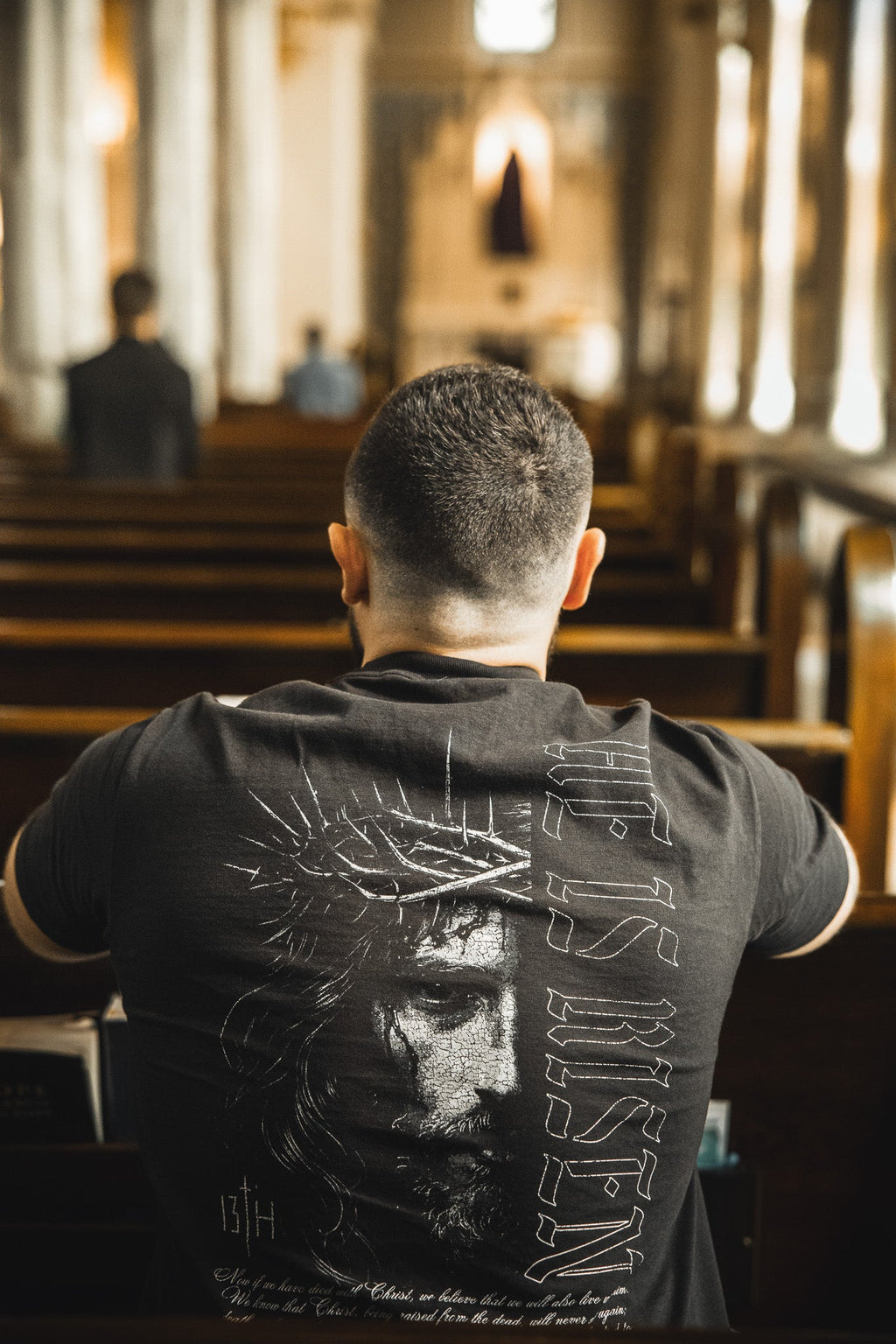 Black graphic t-shirt showing full back portrait and vertical symbol print