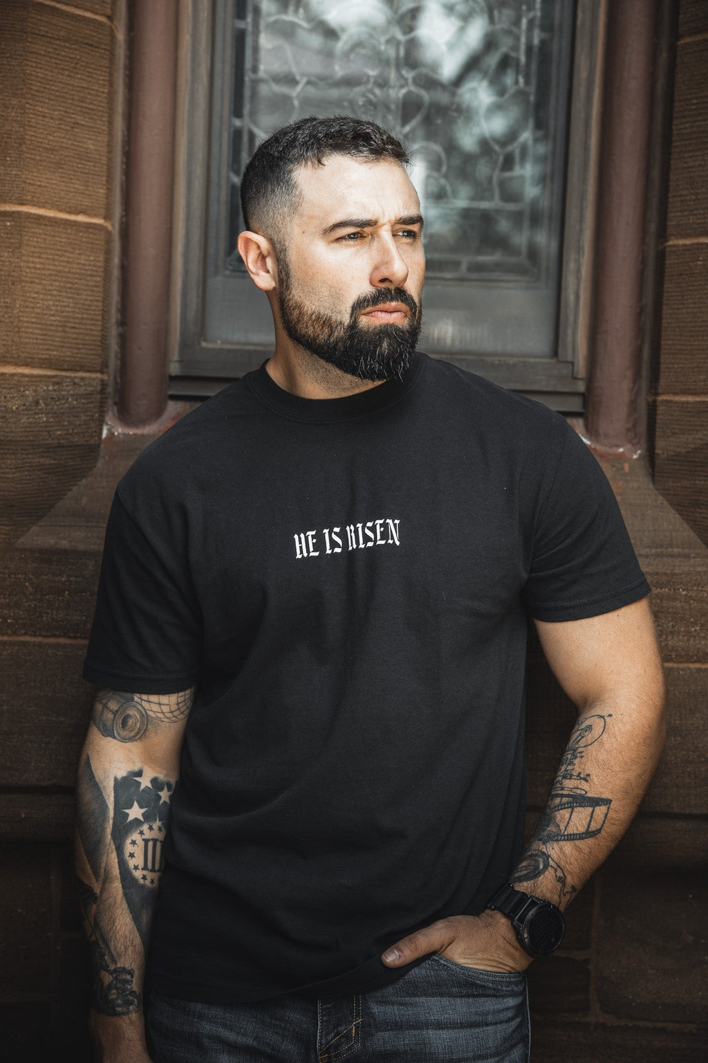 Black crew-neck t-shirt with small front text logo
