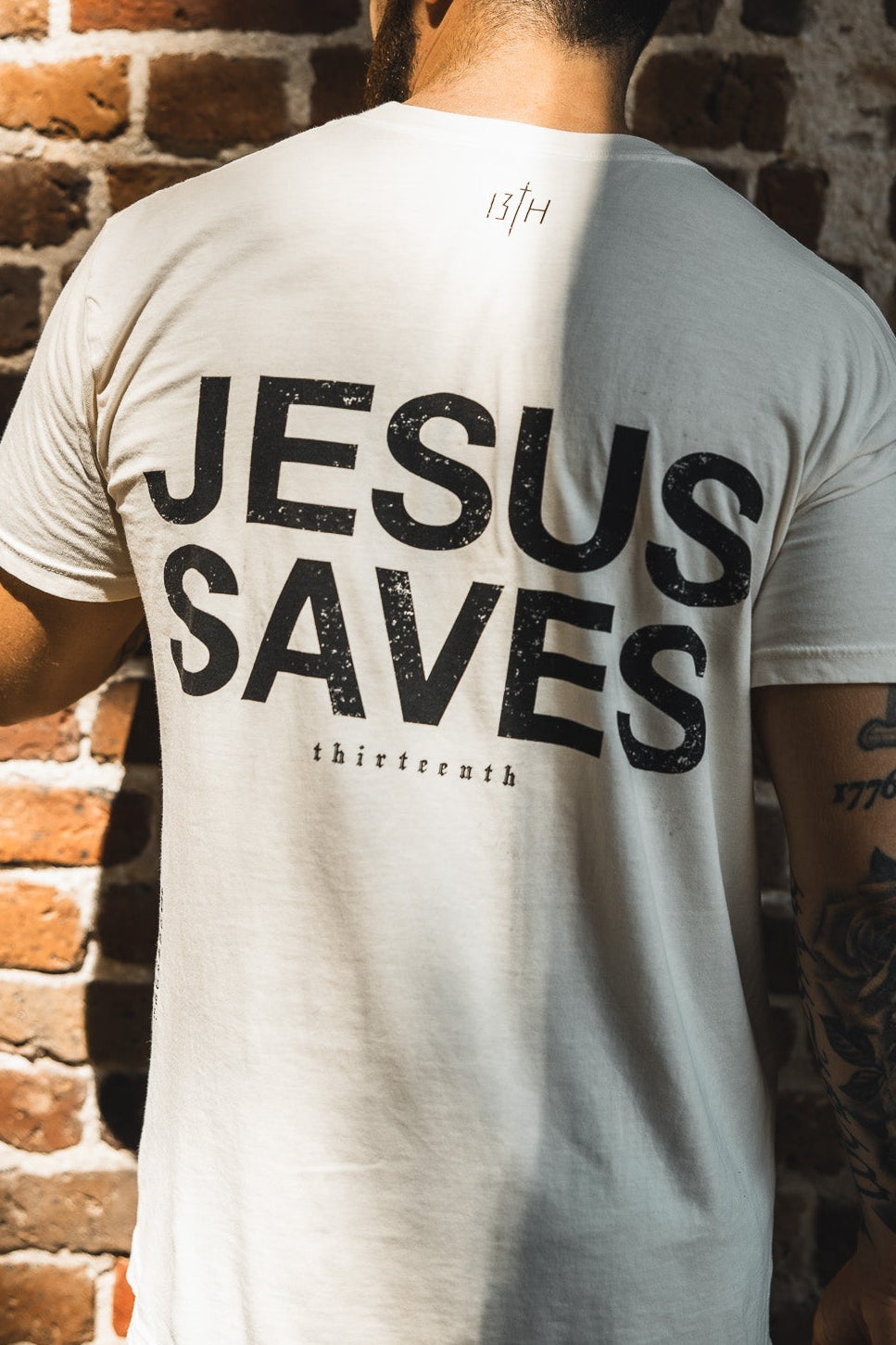 Ivory graphic T-shirt, back print with large “JESUS SAVES” text