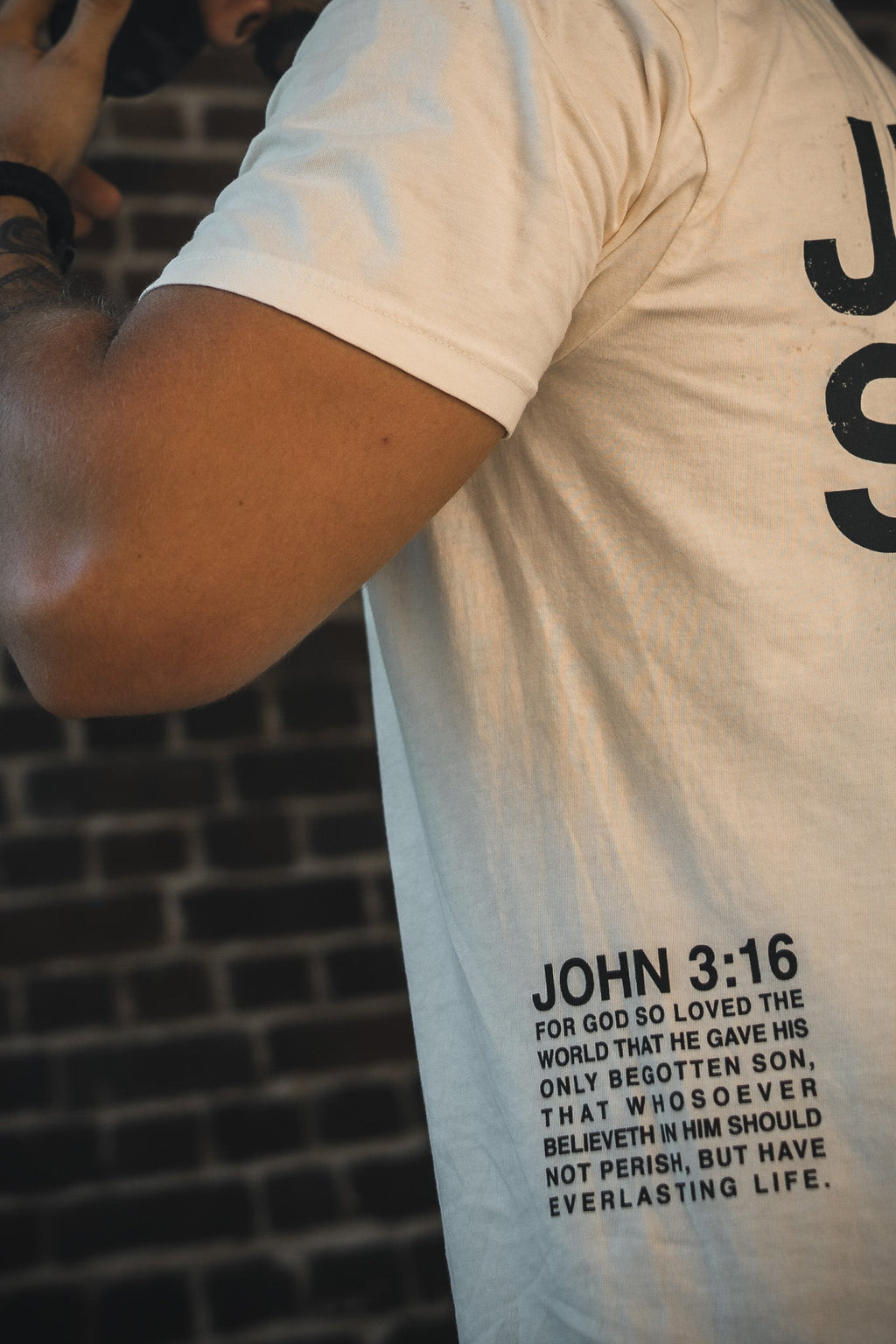 Ivory graphic T-shirt sleeve and chest, “JOHN 3:16” text print