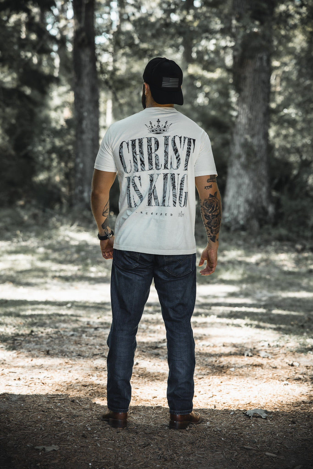 Ivory premium tee back view with large 'CHRIST IS KING' graphic and crown