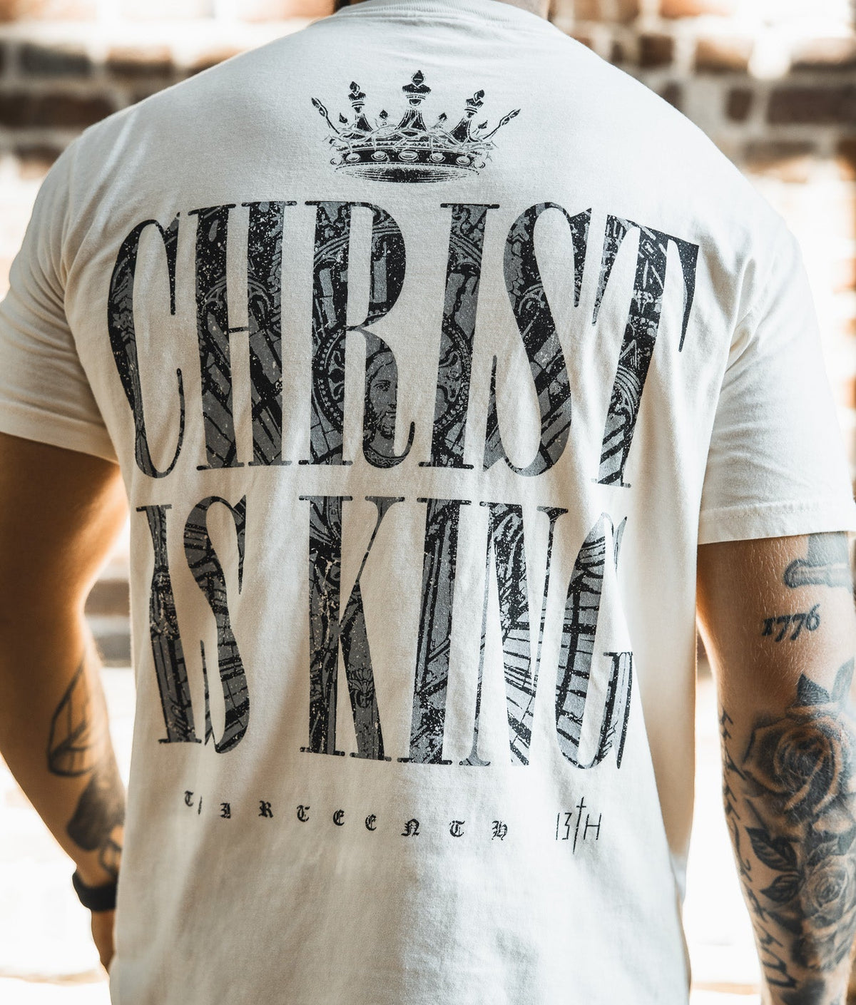 Ivory premium tee back view with oversized 'CHRIST IS KING' graphic and crown