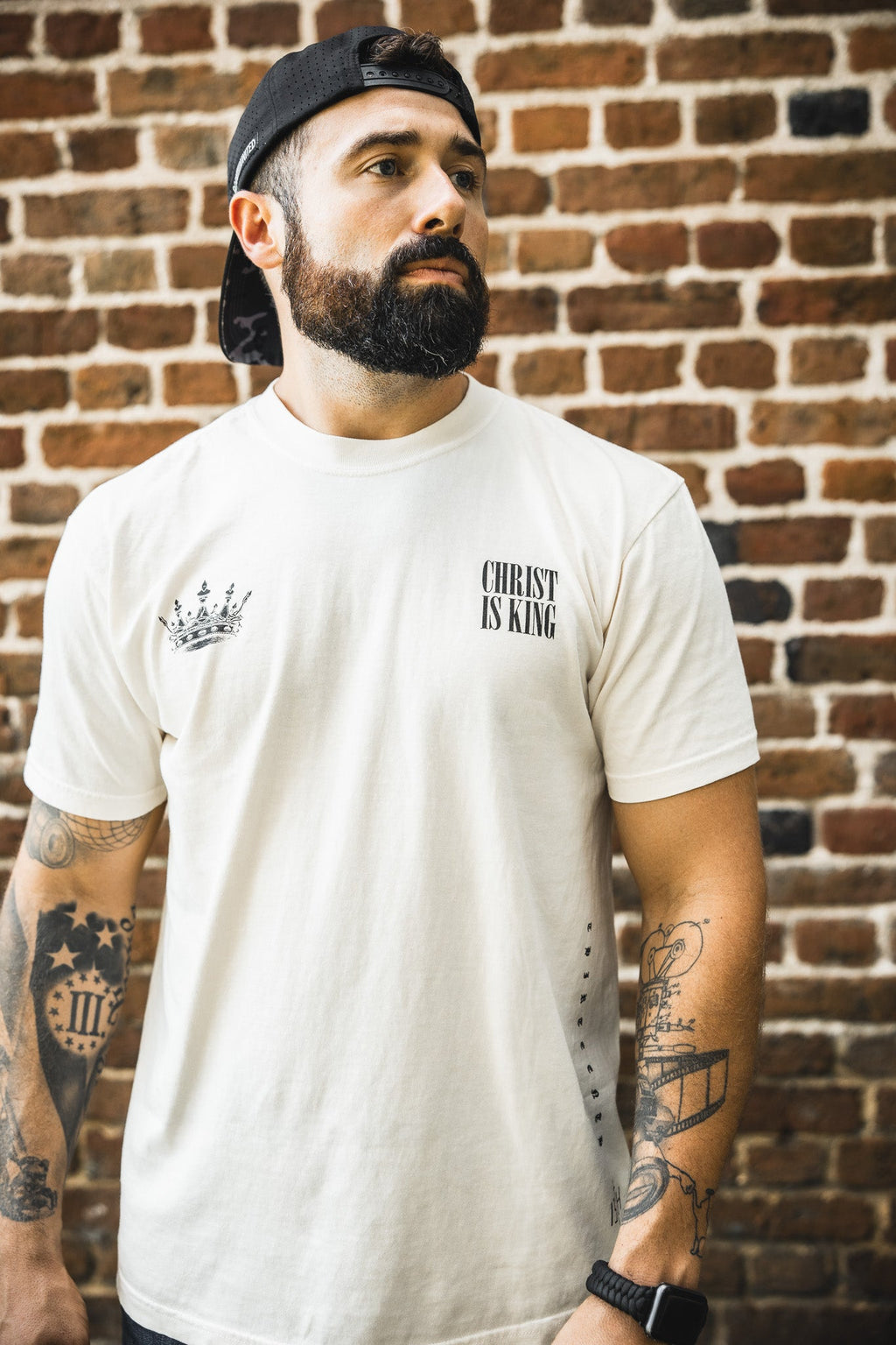 Ivory premium tee with small front crown and 'CHRIST IS KING' text