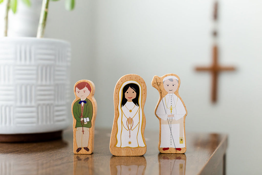 Wooden character figure set with three standing saint cutouts