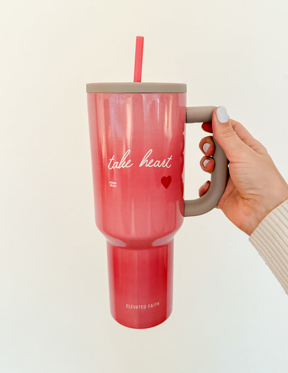 40 oz Ascend tumbler, pink with beige lid and red straw, side handle held