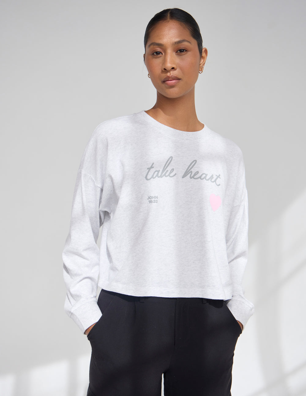 Heather gray long-sleeve cropped women's tee with crew neck, script text, and pink heart