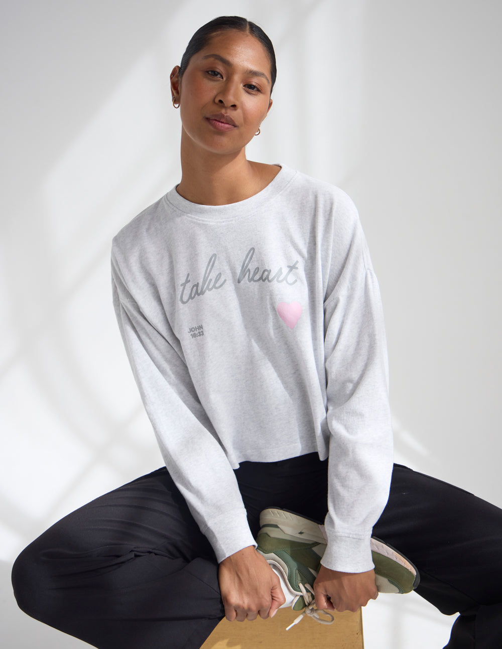 Heather gray long-sleeve cropped tee with script text and small pink heart on chest