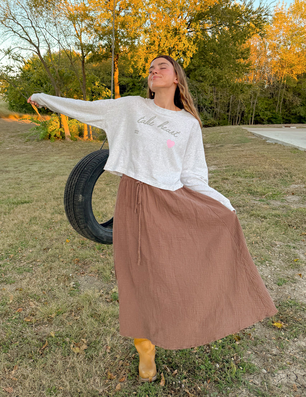 Heather gray cropped long-sleeve women's tee with pink heart and script text, side view