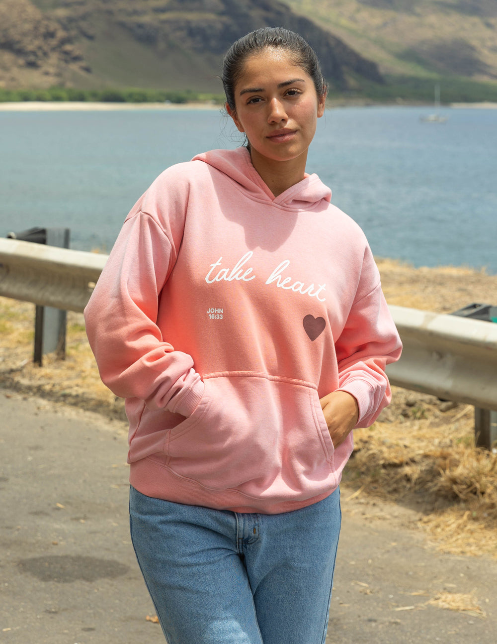 Pink unisex hoodie with 'take heart' script and heart graphic, drawstring hood