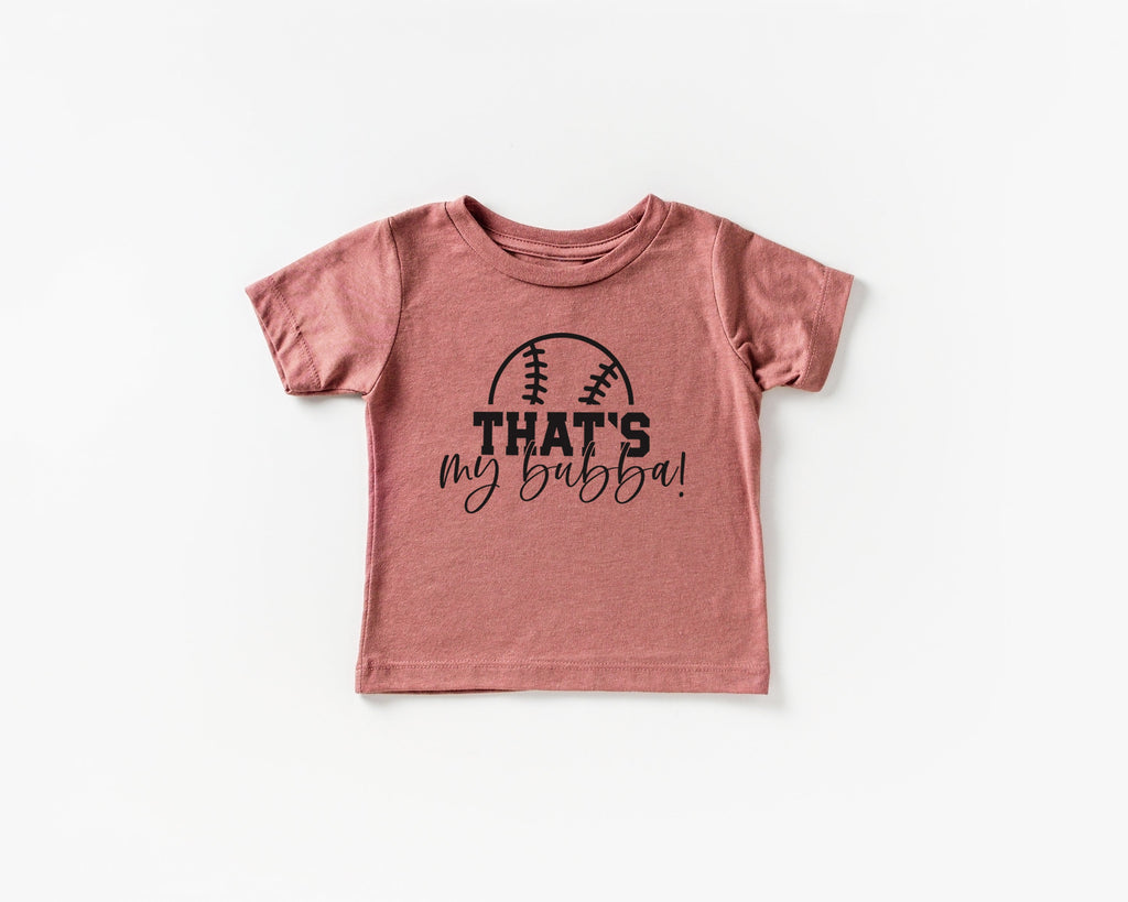 Dusty rose kids graphic T-shirt with football logo and text "THAT'S my bubba!"