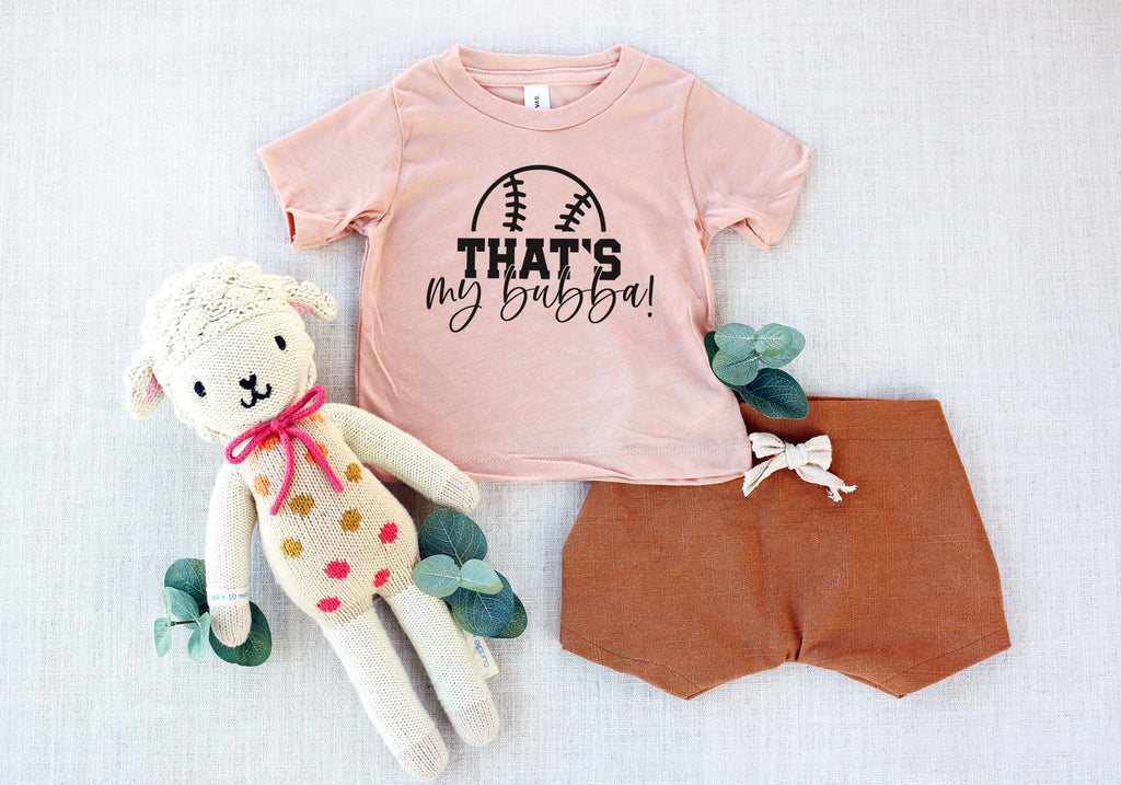Blush kids graphic T-shirt with football logo and text "THAT'S my bubba!"