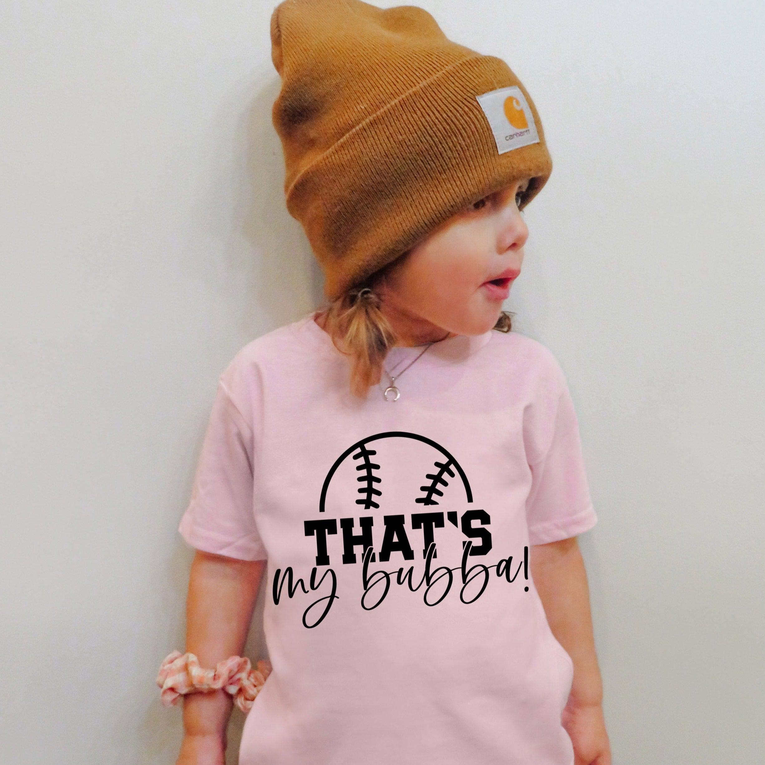 Pink kids graphic T-shirt with football logo and text "THAT'S my bubba!"