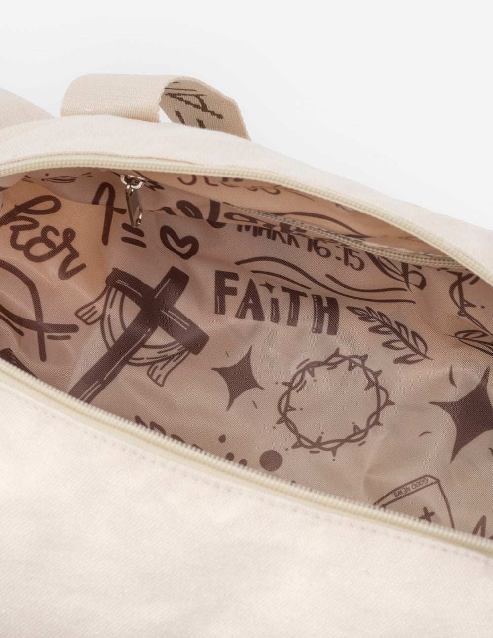Cream duffel bag interior with Faith typography and religious line art print.