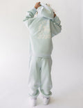 Light mint kids hoodie with hood, kangaroo pocket, and circular 'Future is Bright' graphic