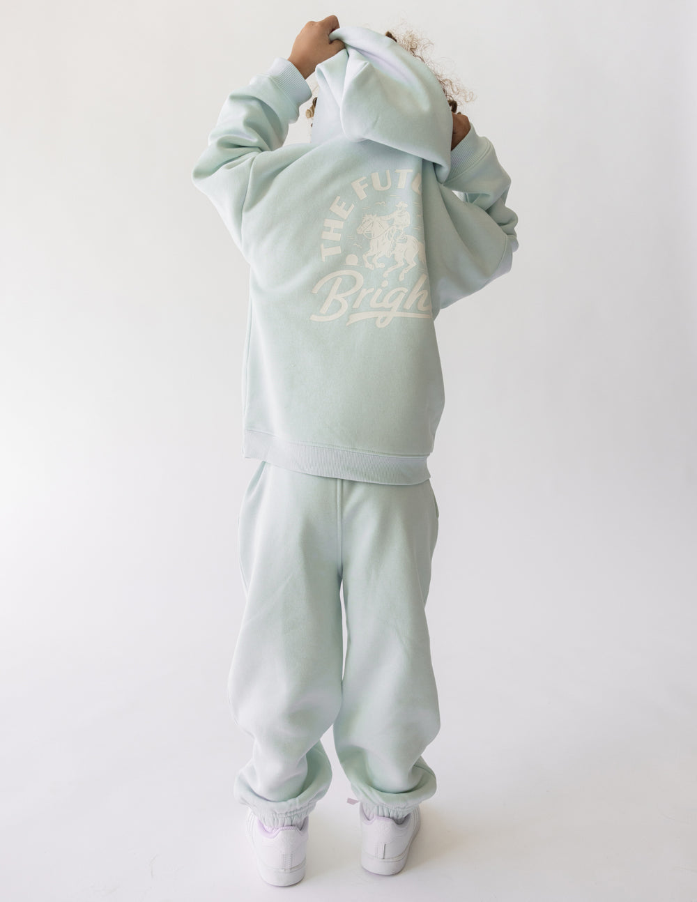 Light mint kids hoodie with hood, kangaroo pocket, and circular 'Future is Bright' graphic