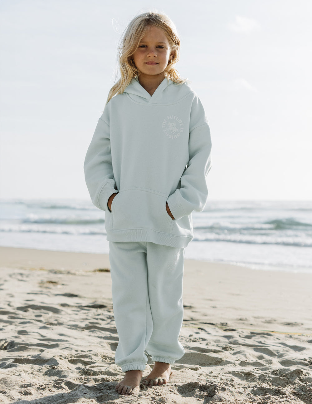 Light mint kids hoodie with hood and small chest logo graphic, front view