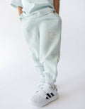 Kids mint sweatpants with elastic cuffs and FUTURE IS BRIGHT graphic on thigh