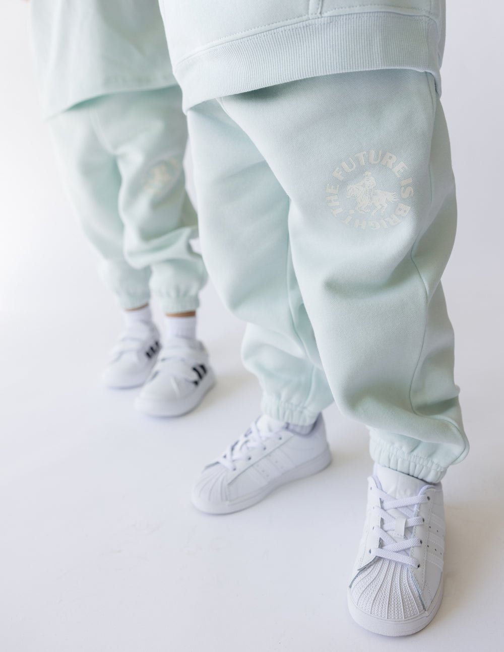 Kids mint sweatpants with ribbed ankle cuffs and FUTURE IS BRIGHT logo on leg