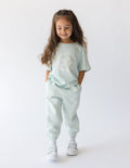 Kids mint graphic T-shirt with crew neck and short sleeves, featuring centered text and horse print.