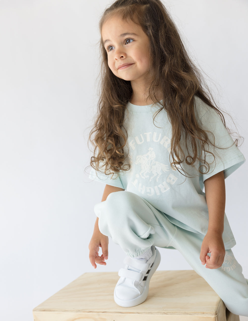 Kids mint graphic T-shirt with crew neck and short sleeves, worn with matching pants.