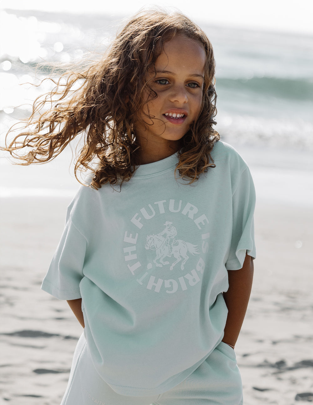 Kids mint graphic crew-neck T-shirt with centered text and horse illustration on the front.