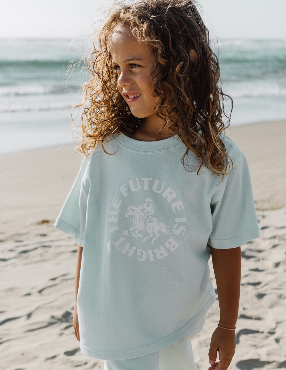 Kids mint graphic crew-neck T-shirt with front text and horse illustration, short sleeves.