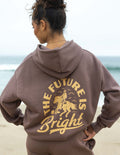 Mauve unisex hoodie with hood and gold rodeo graphic on back, kangaroo pocket.