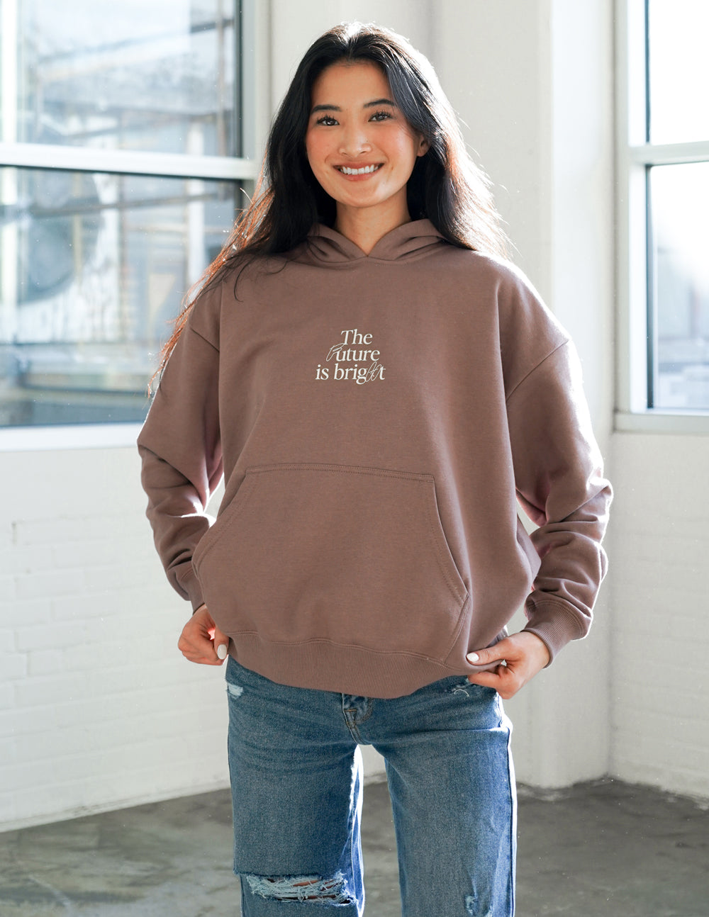 Unisex mauve hoodie with hood and front pocket; 'The Future is bright' logo.