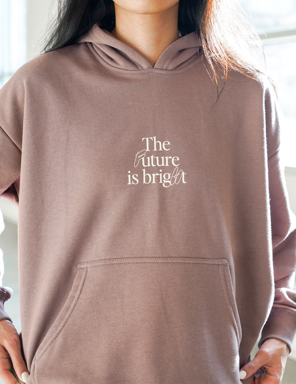 Mauve unisex hoodie with hood and front pocket; chest 'The Future is bright' print.