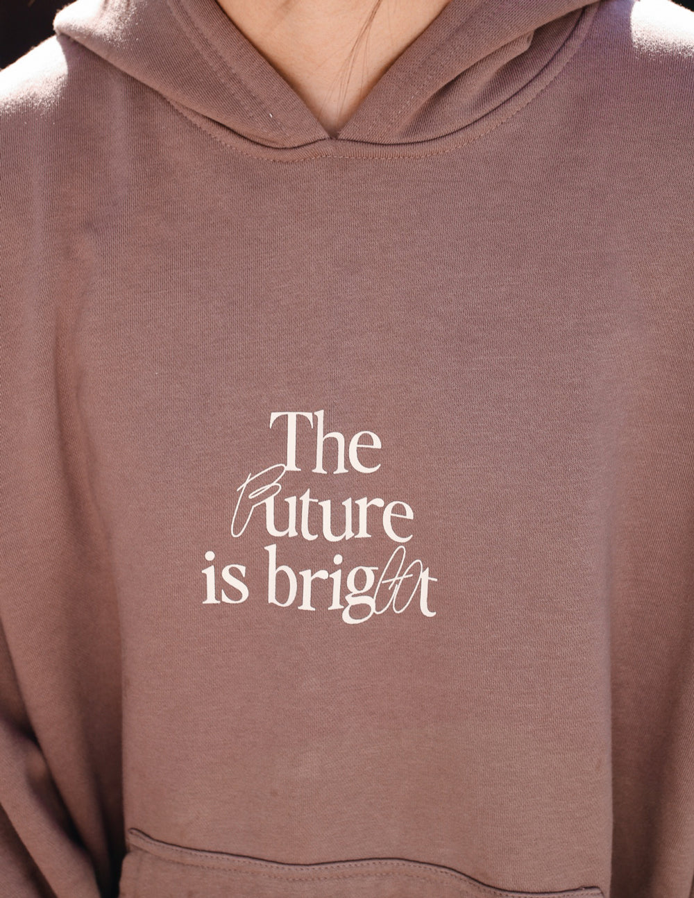 Mauve unisex hoodie with hood and 'The Future is bright' chest graphic.