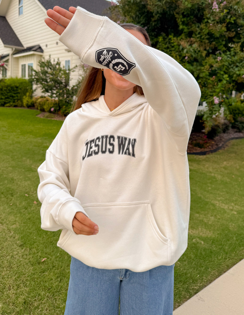 Unisex white hoodie with “JESUS WAY” front print and crest patch on cuff