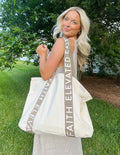 Large everyday tote with canvas body and brown logo print straps, open top