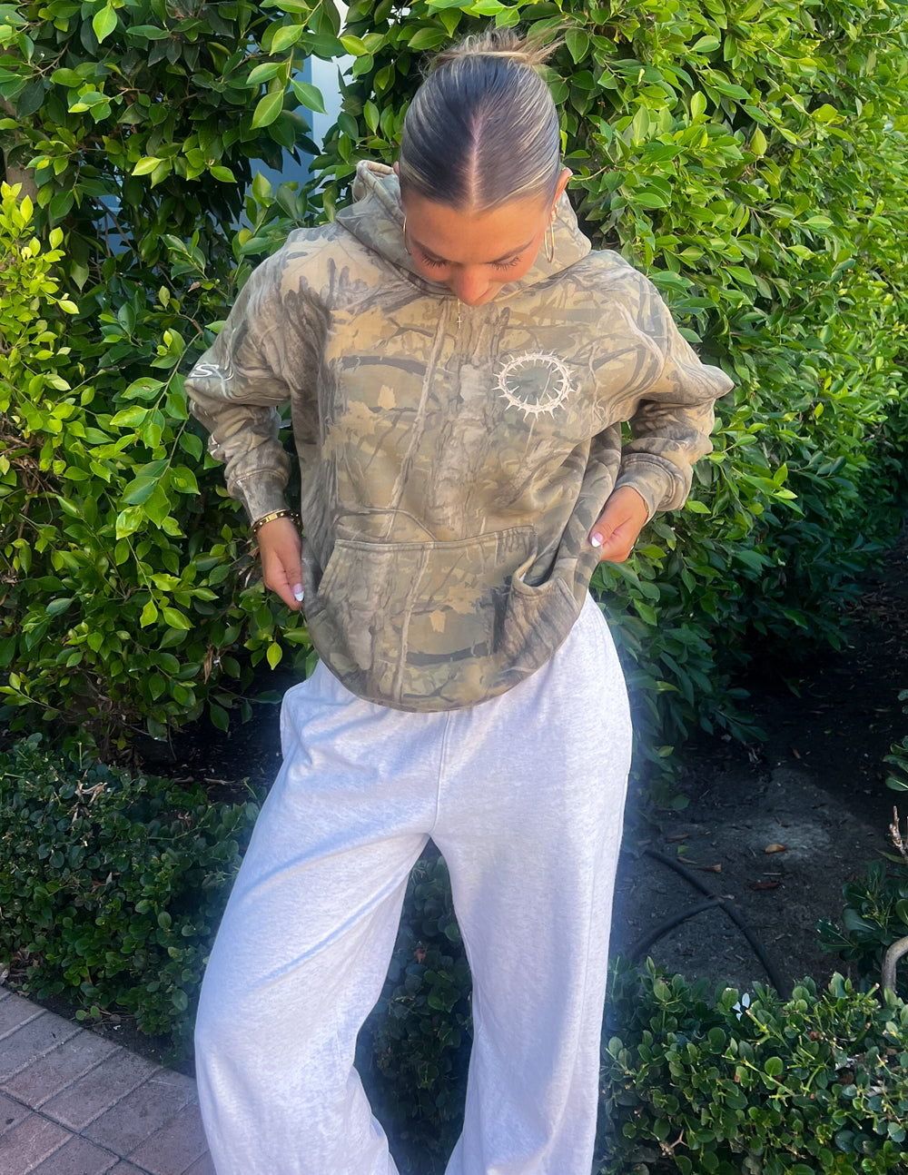 Unisex camo hoodie with hood, kangaroo pocket, and front circular print