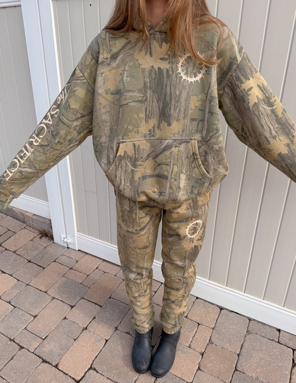 Camo unisex sweatpants with white circle graphic at front leg