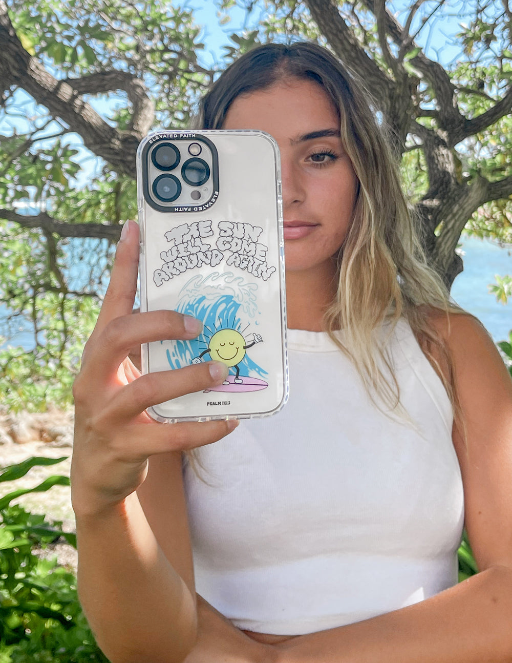 Transparent phone case with smiling sun, clouds, and blue wave art