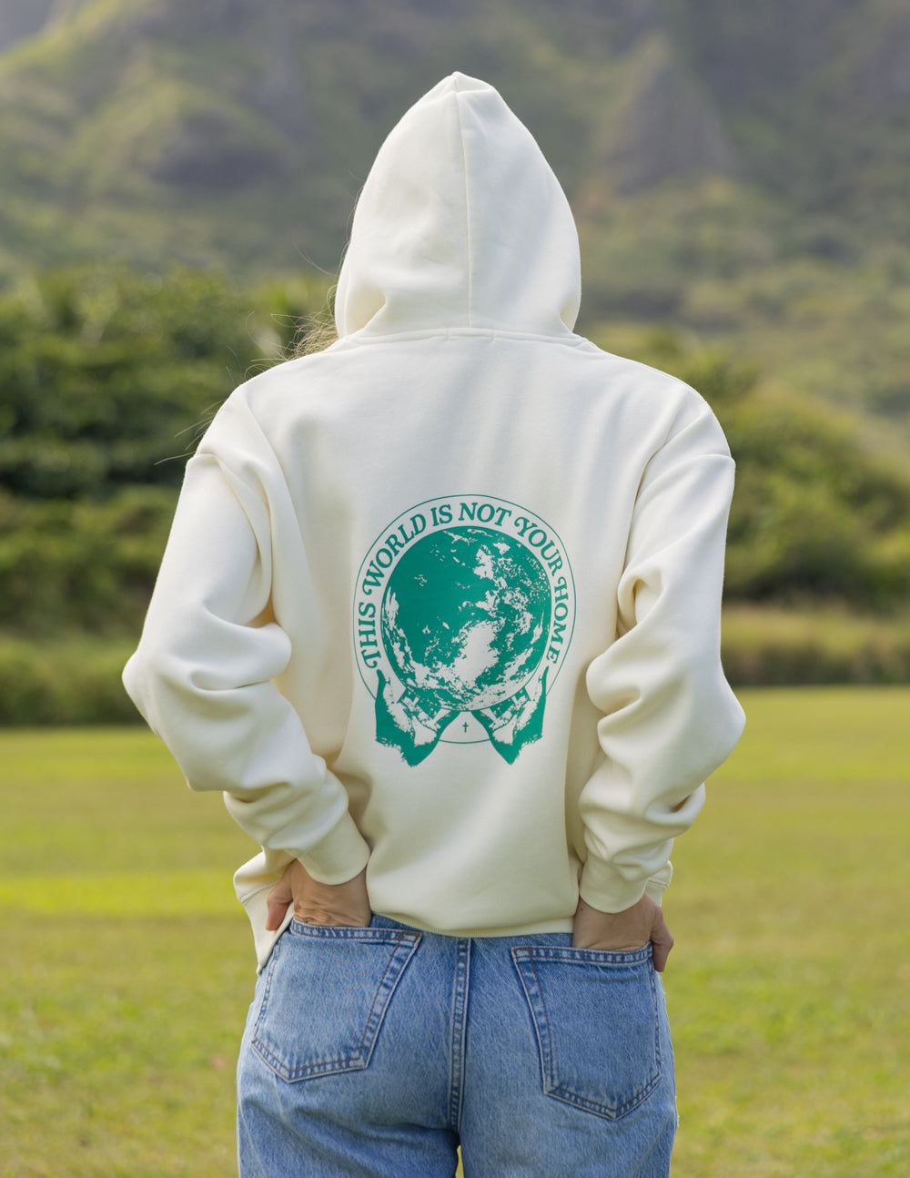 Light cream unisex hoodie with green back graphic and kangaroo pocket