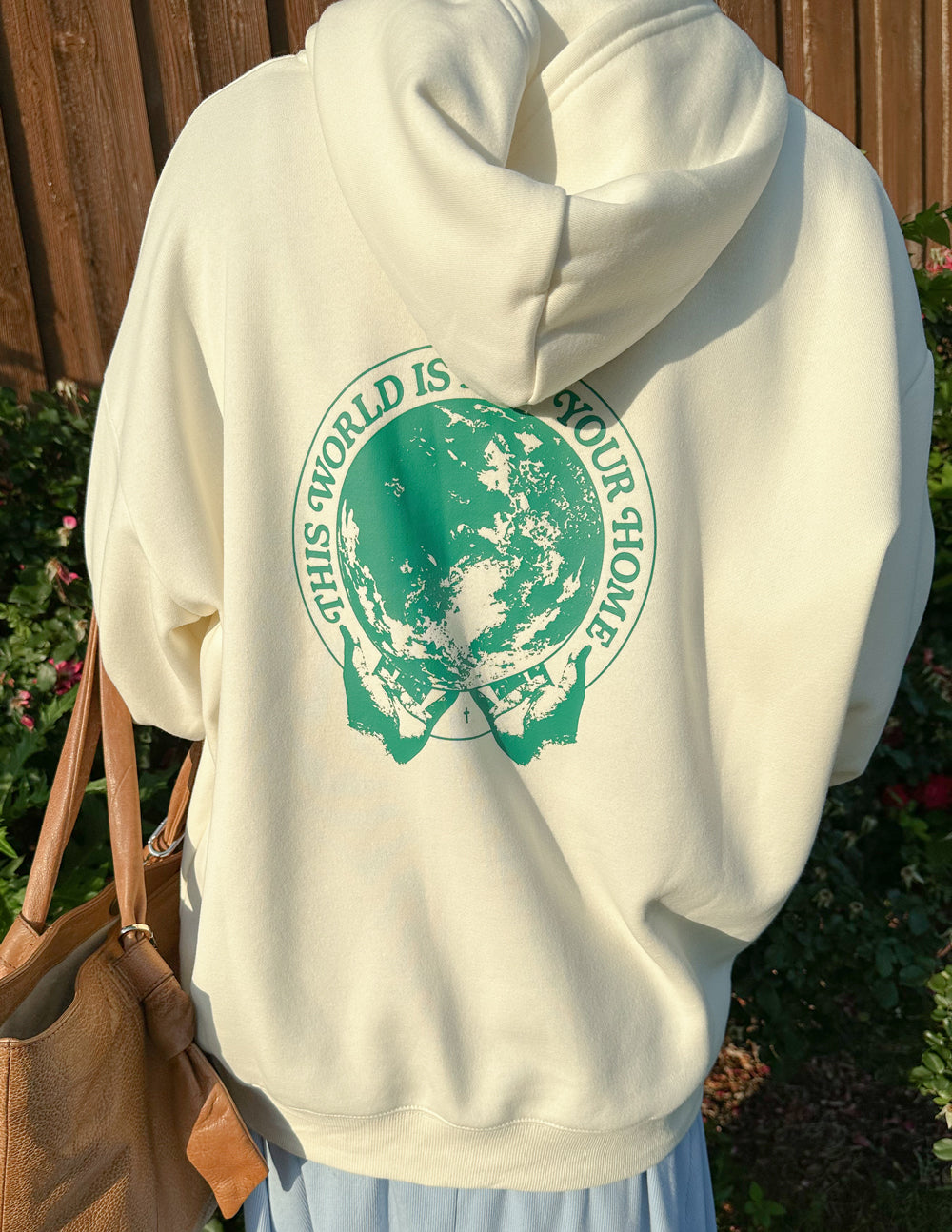 Light cream unisex hoodie back view with large green graphic