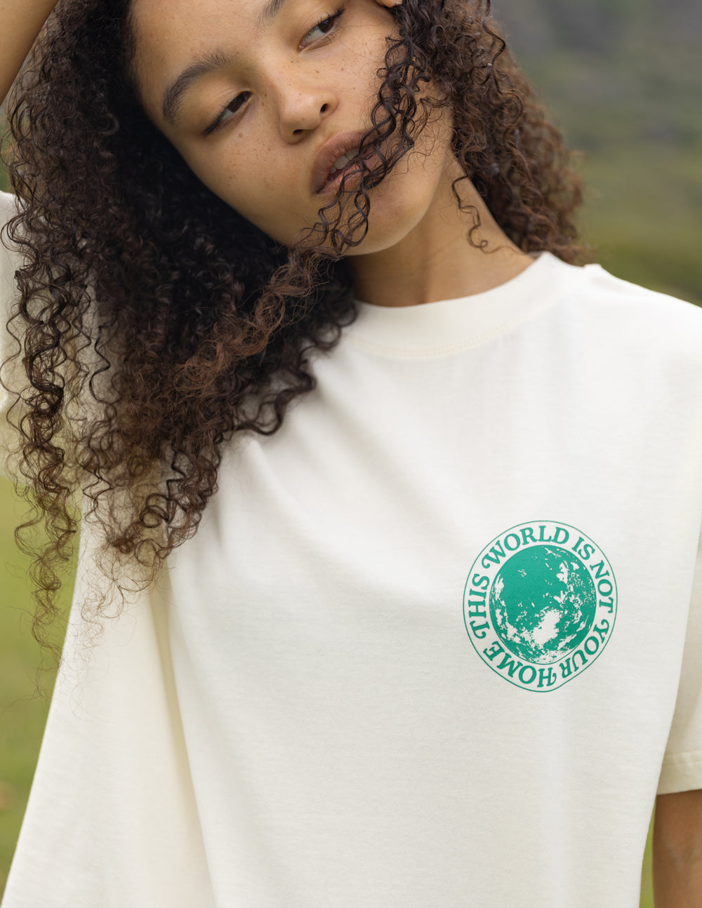 Unisex T-shirt in white with green circular chest graphic detail