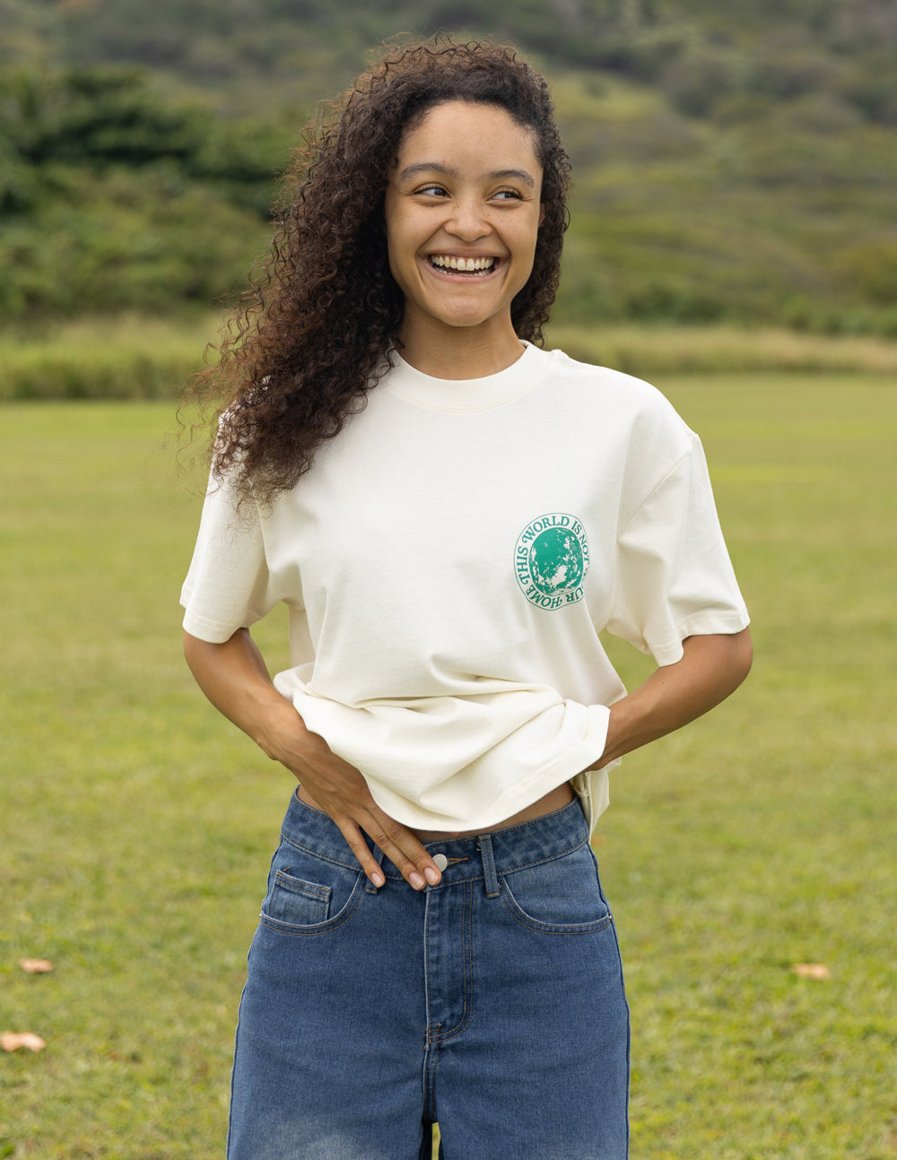 Unisex T-shirt in white with small green circular chest graphic logo